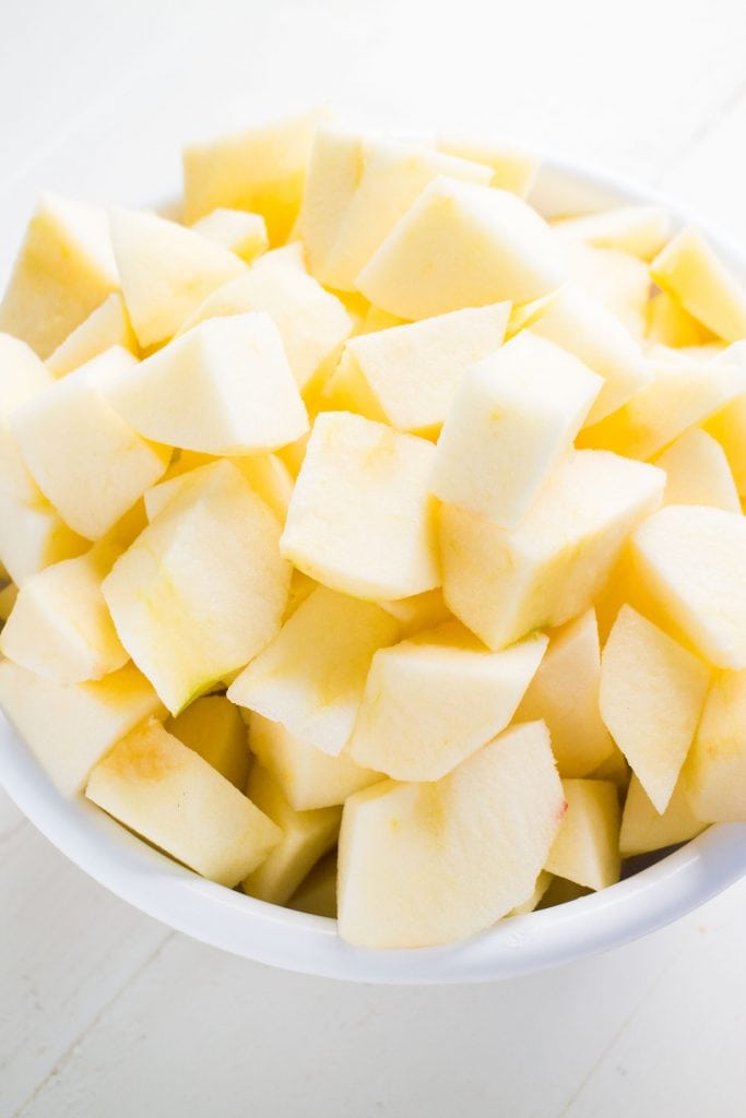 chopped up apples in white bowl