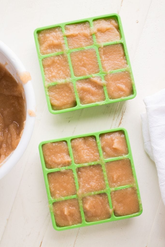 green freezer containers filled with baby food