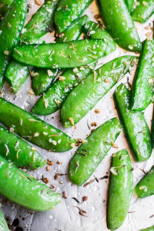 HEALTHY Roasted Sugar Snap Peas Recipe are easy to make and ready in 8 minutes!  Sprinkle with garlic, thyme and salt for a healthy snack!  Adults and kids both love this easy delicious pea recipe!  
