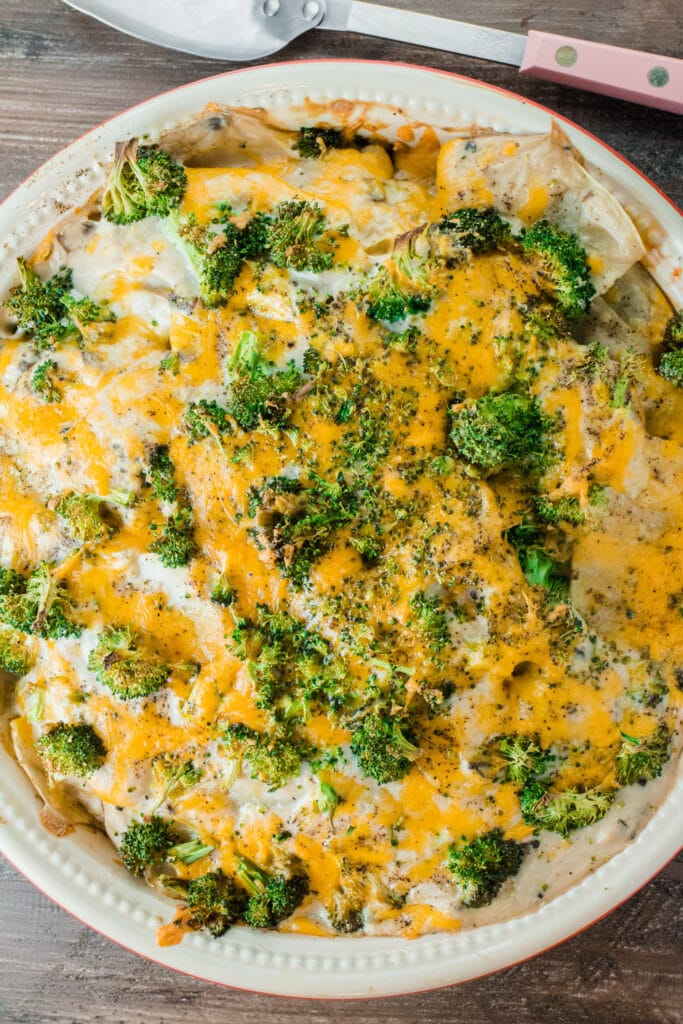 baking dish filled with scalloped potatoes with cheese on top.