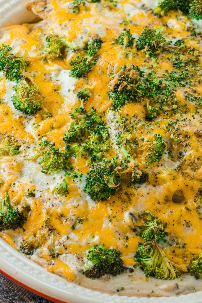 closeup of cheesy scalloped potatoes with broccoli.