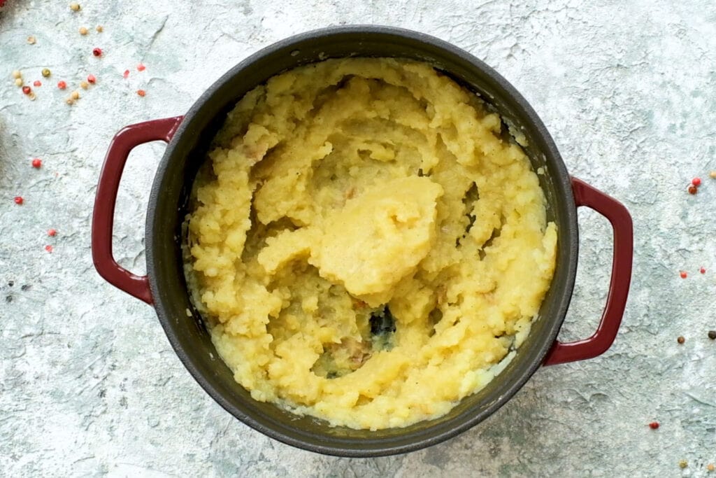 creamy mashed potatoes in red pot.