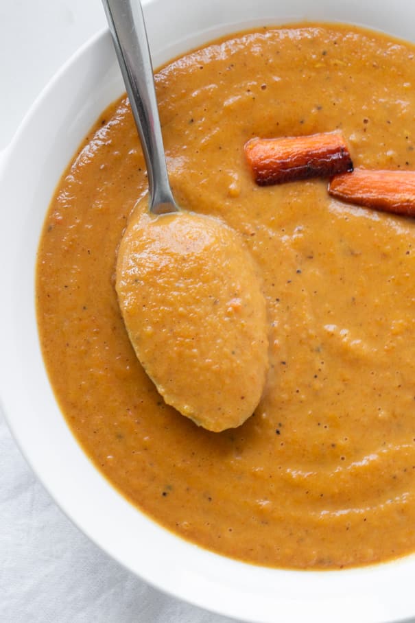 EASY to make Butternut Squash Soup that's only 310 calories a serving! Roasted squash, carrots and onions make this a healthy creamy soup! Best served with crusty bread! Vegan dairy free recipe option included.