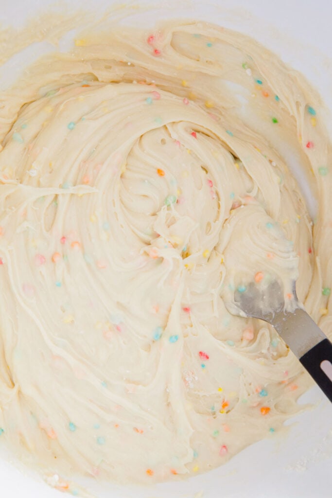 sprinkle confetti cake mix in bowl mixed with wet ingredients.