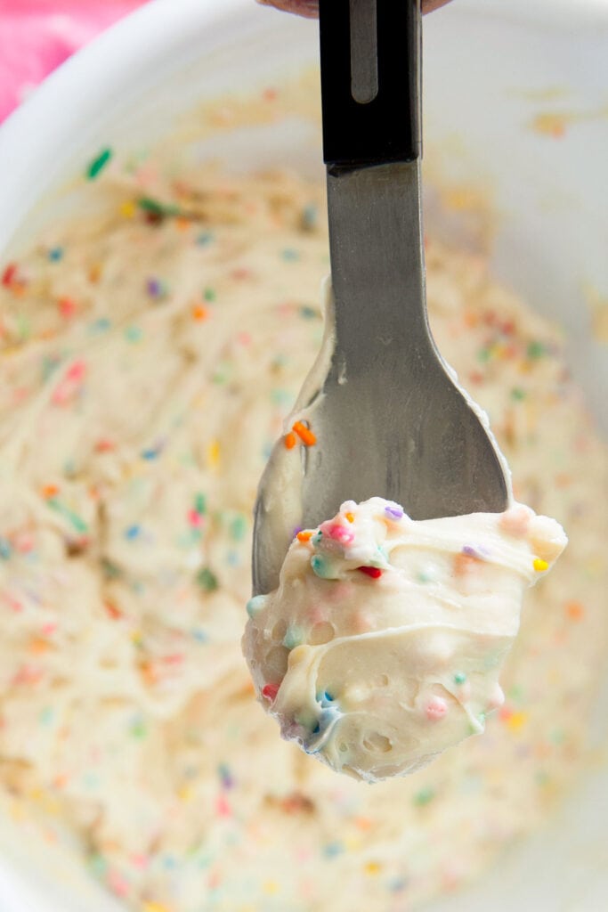 spoon filled with cake batter mix.