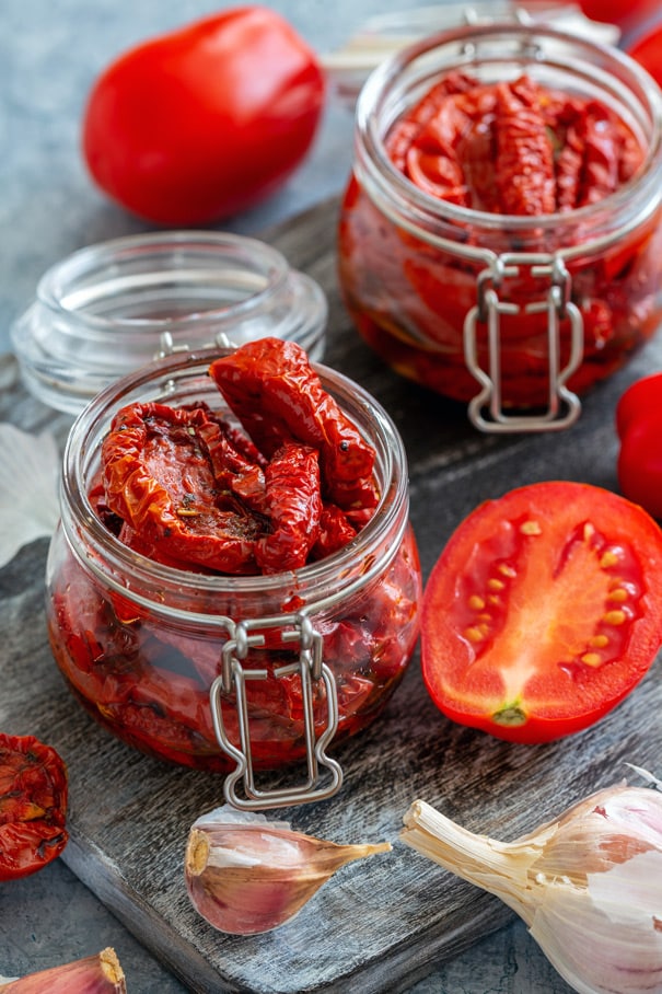 Oven Baked Sun-dried Tomatoes in olive oil and Italian spices recipe.  This easy homemade recipe will leave your kitchen smelling great and you saying MMMMMM! Includes directions on how to make and freeze sun-dried tomatoes. Use them in pasta, chicken, shrimp, bread, pizza, dip and so many other recipes!