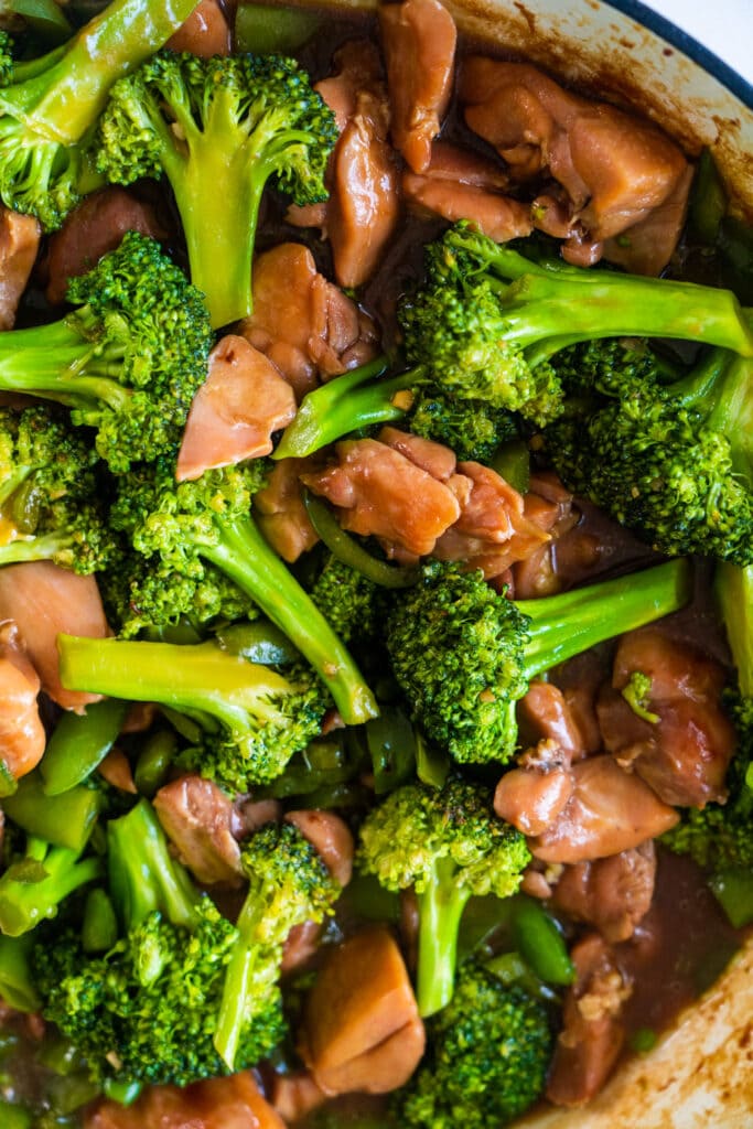 saucy chicken and broccoli in pan.