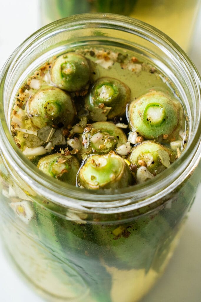 top down view of pickled okra in mason jar.
