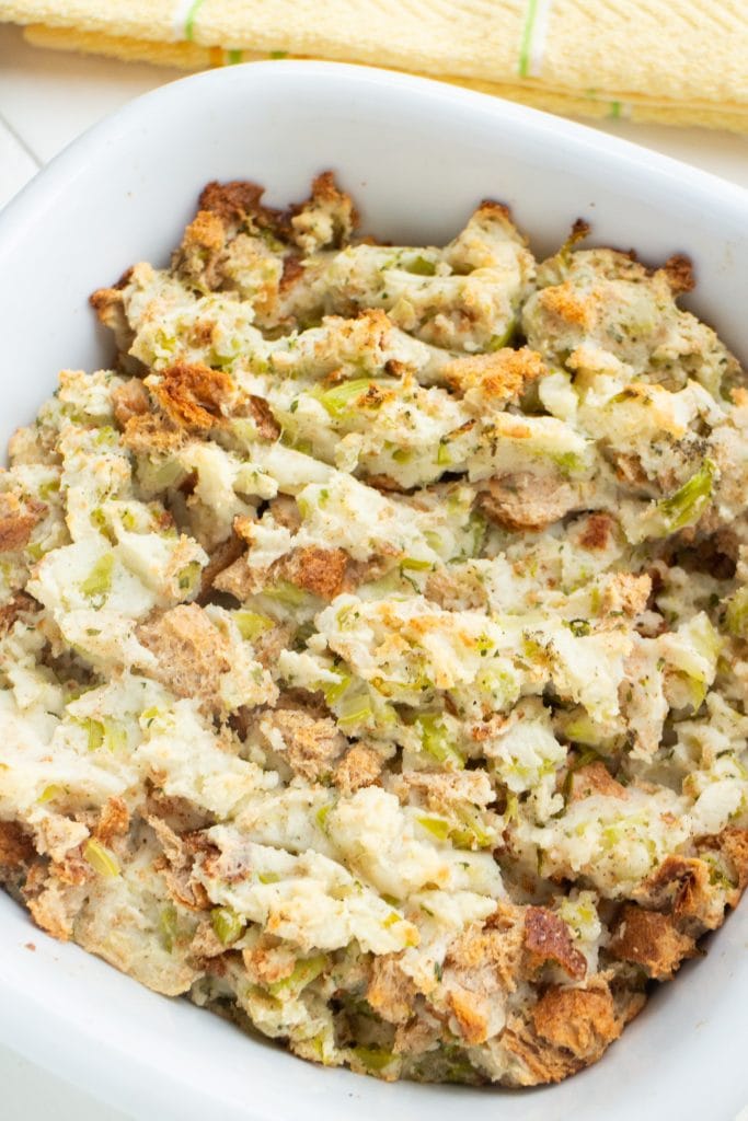 potato stuffing with a browned top in baking dish on table.