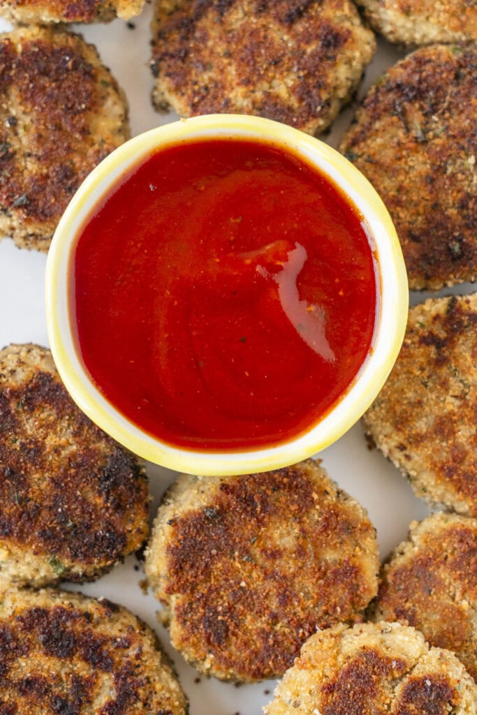 eggplant nuggets with small bowl of ketchup in the middle.
