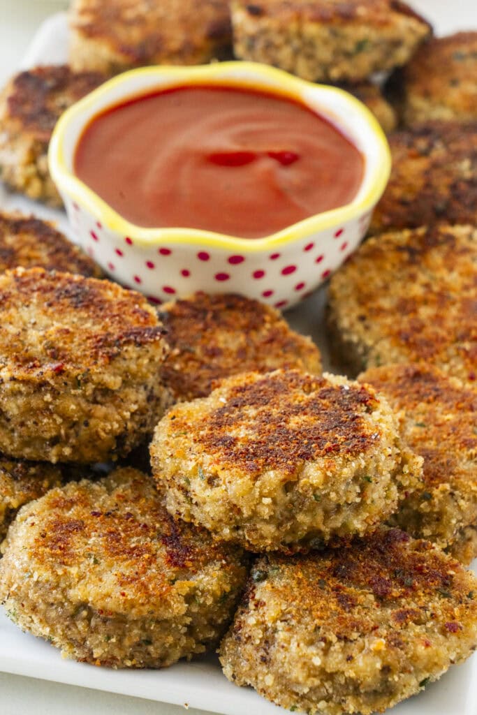 eggplant nuggets with ketchup on table. 