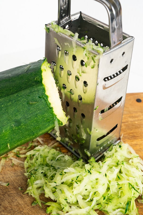 Easy step by step instructions on how to freeze zucchini without needing to blanch it. This quick method saves you time and freezes zucchini for up to a year. Perfect for making zucchini bread and treats with!