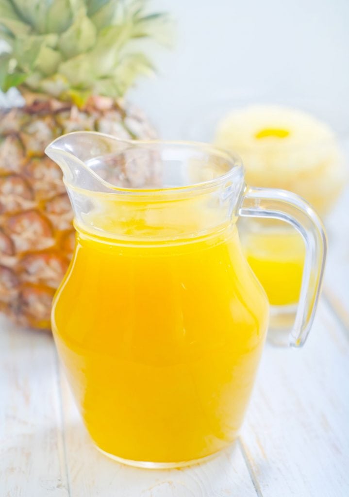 glass pitcher filled with pineapple apple juice