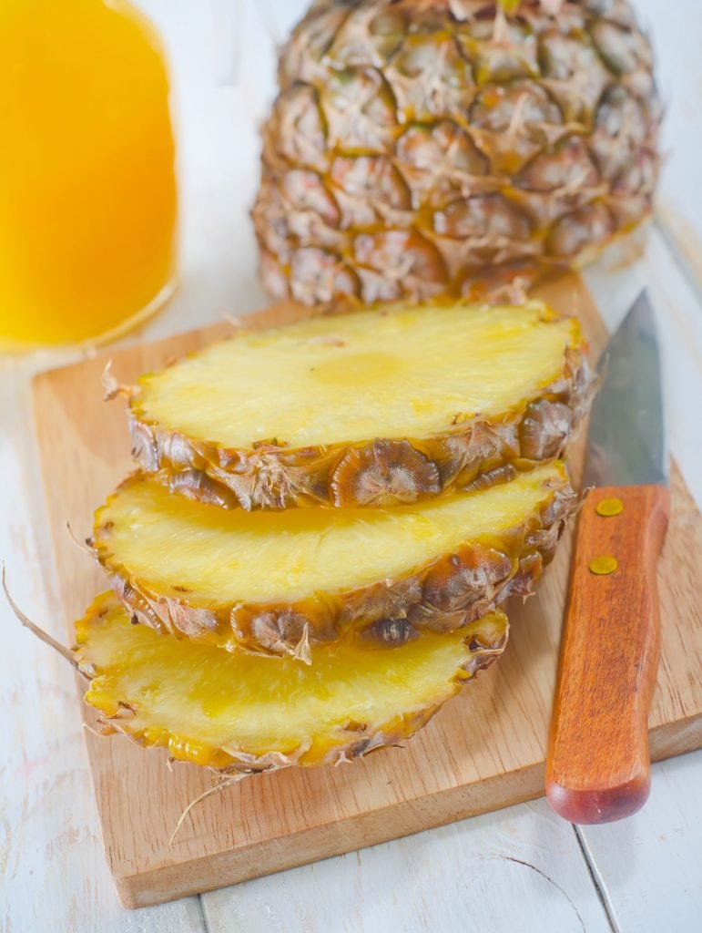chopped pineapple on cutting board
