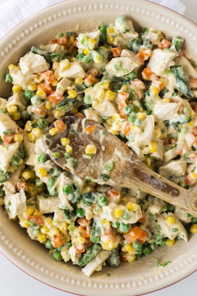 ingredients being stirred in pie dish.