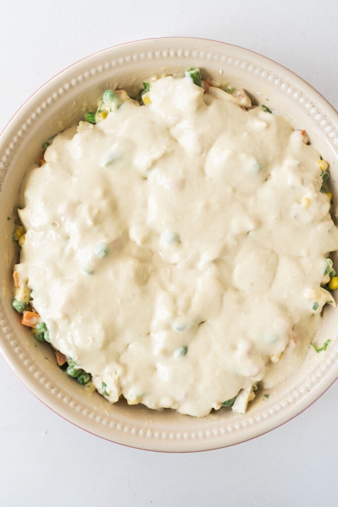 bisquick pie crust mixture poured on top of vegetables in pan.