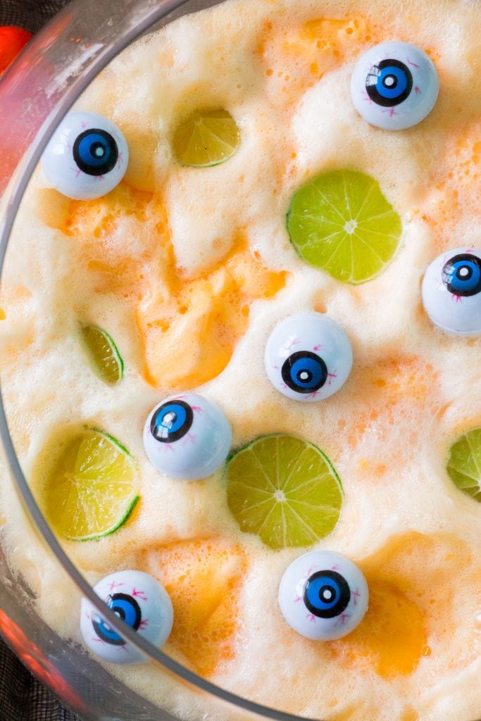 spooky halloween punch with eyeballs on top served in glass bowl