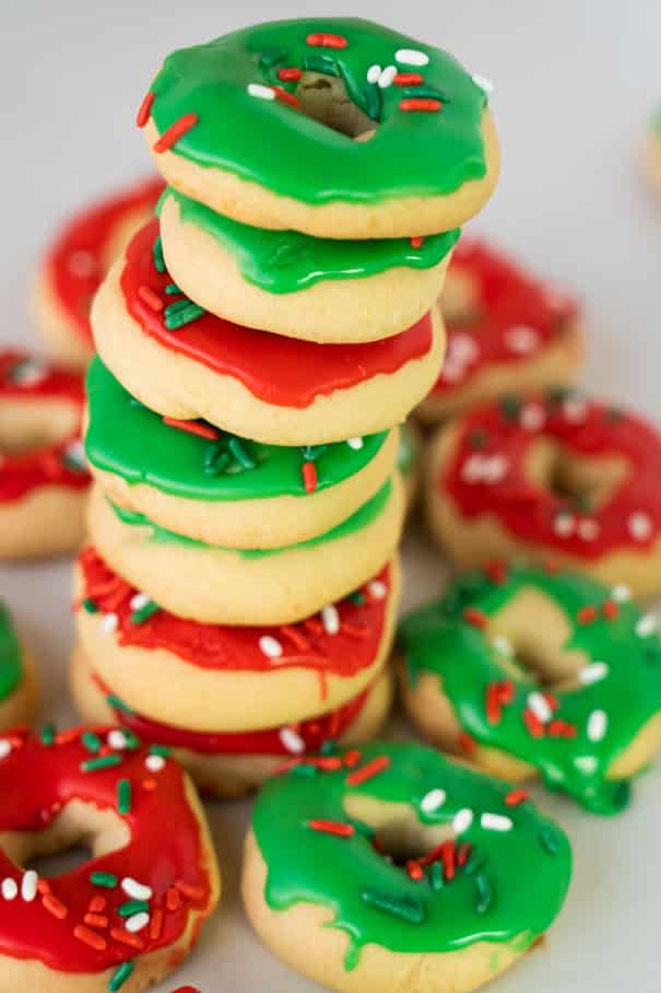 Easy to make Christmas Donut Cookies recipe.   Each sugar cookie is decorated with icing and sprinkles to look like a donut.  If you're looking for the cutest homemade Christmas co