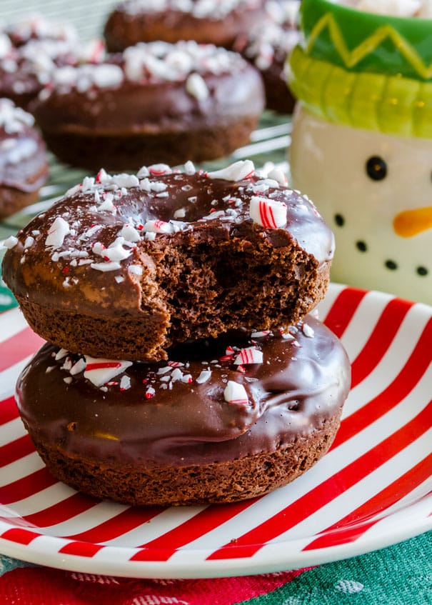 These Christmas donuts are fluffy baked chocolate donuts coated in chocolate frosting then topped with crushed peppermint candy canes. A fun and festive dessert that’s perfect for Christmas breakfast!