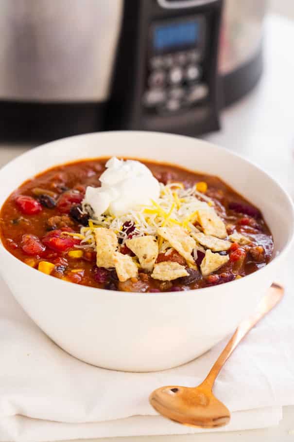 Easy Slow Cooker Taco Soup recipe, made in the crockpot with ground beef and 8 cans. This creamy soup is ready in 4 hours on high or 8 hours on low.