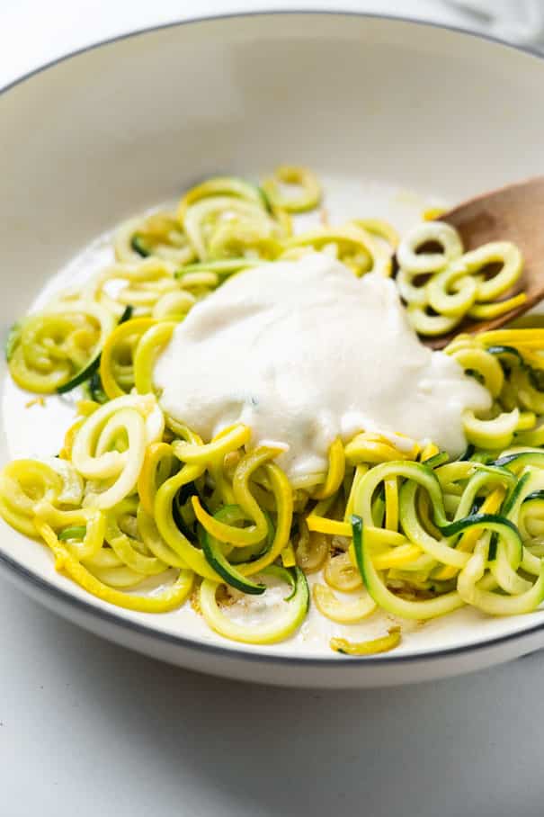 Easy to make Keto Alfredo Sauce that's ready in 10 minutes.  You're going to love this low carb recipe to serve over zoodles! Made with heavy cream, broth, cream cheese and Parmesan cheese. 