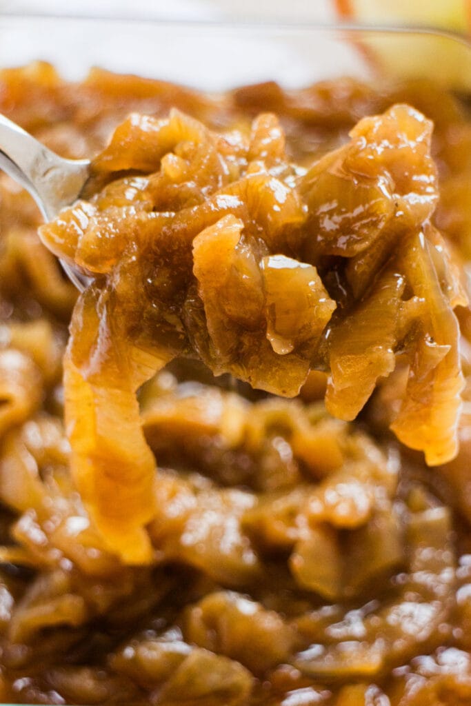 closeup of spoon serving caramelized onions.