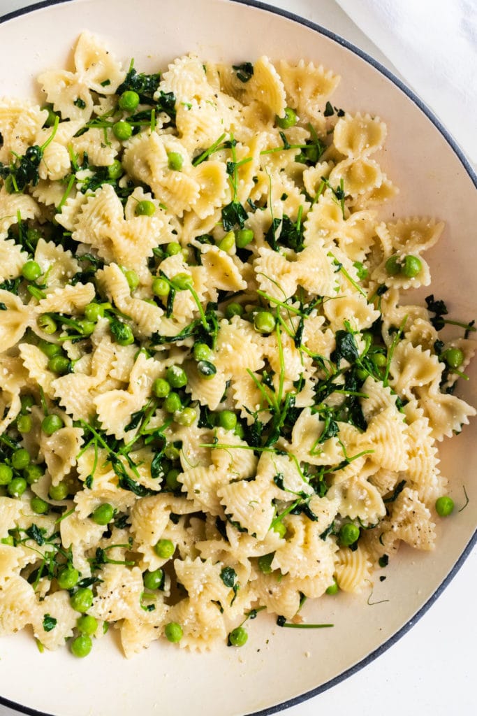 Simple Pea Shoots pasta recipe that's delicious and healthy! Farfalle pasta is mixed with pea shoots, peas and Parmesan cheese to make a 30 minute easy recipe that your family will love! 