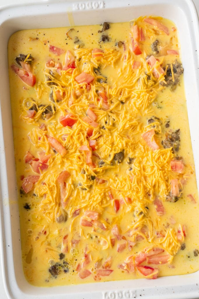 eggs, tomatoes, cheese in baking dish