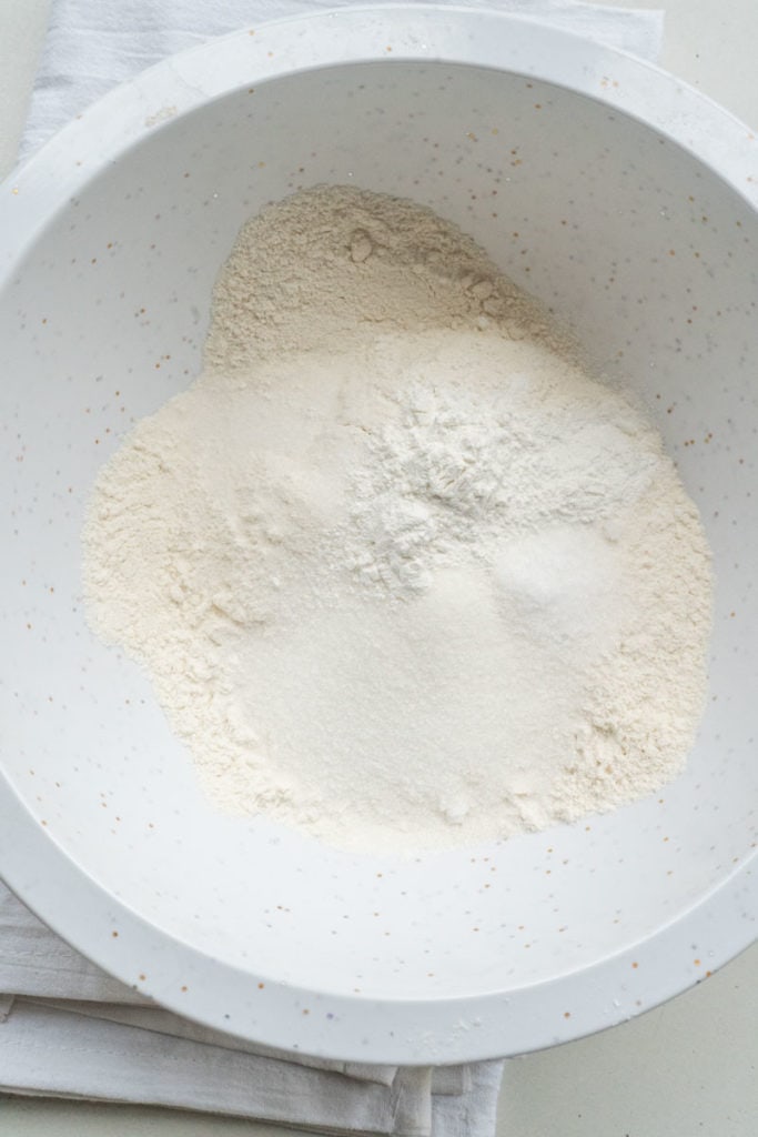 flour, sugar, baking powder and salt in white bowl
