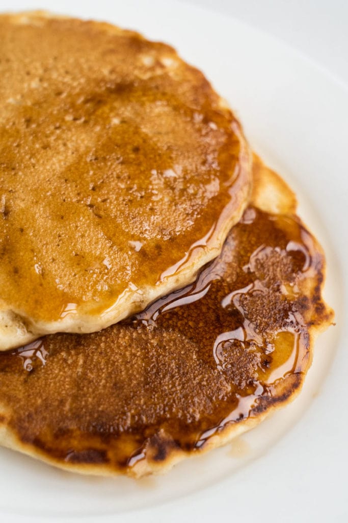 Easy fluffy pancakes that are made with no milk and no eggs.  This homemade recipe is made with simple pantry ingredients and water. 