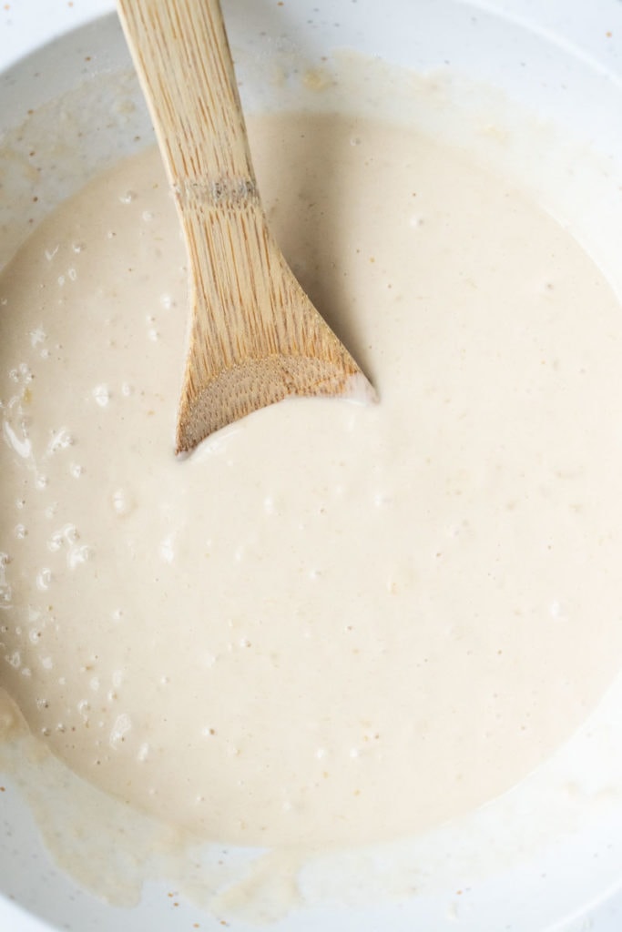 pancake batter with wooden spoon
