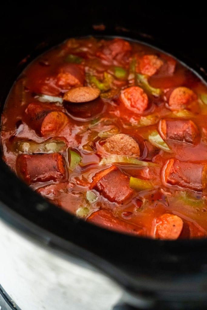 Easy Crock Pot Kielbasa slow cooked with savory tomato sauce, peppers and onions.  Serve over rice, noodles or put on a roll for a sausage sub! 