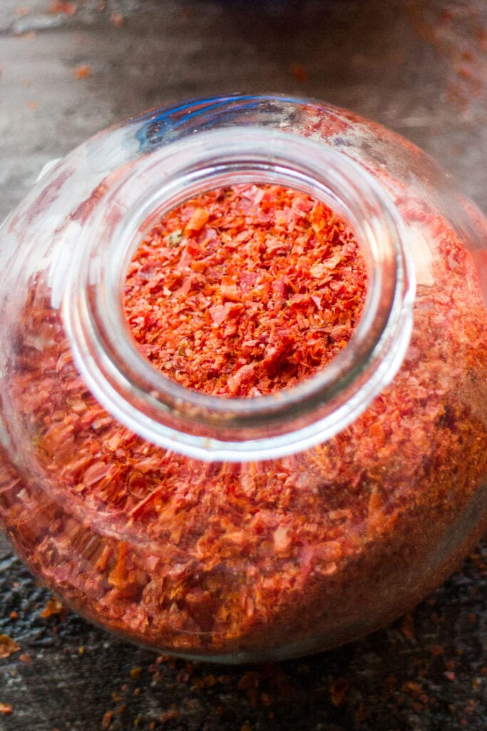 tomato powder in glass spice jar.