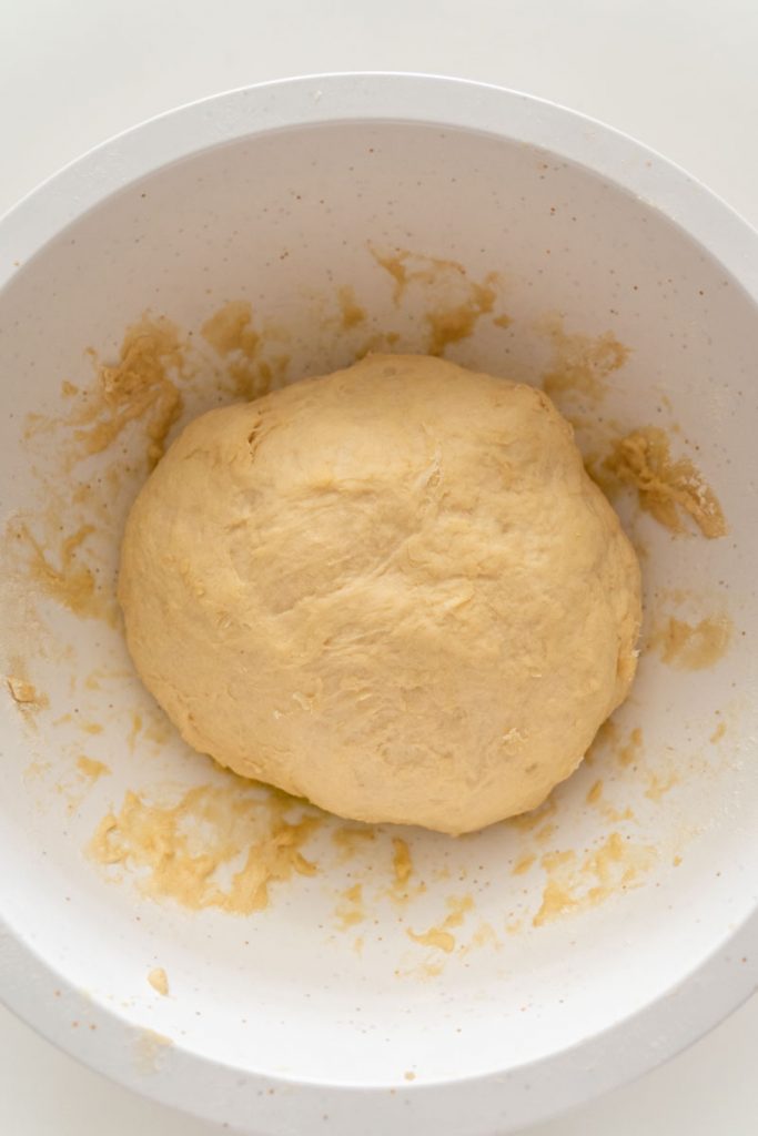 dough ball rising in white bowl