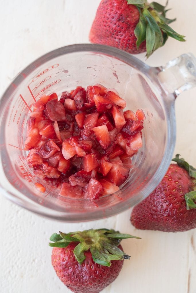 strawberries diced up in measuring cup