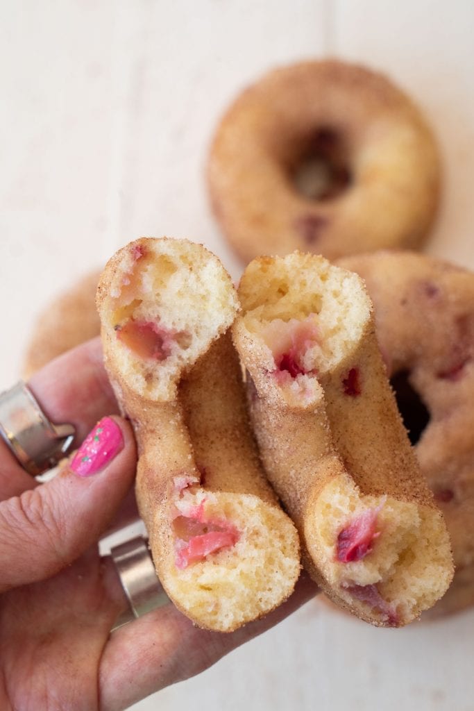 baked strawberry donuts ripped open showing how fluffy they are