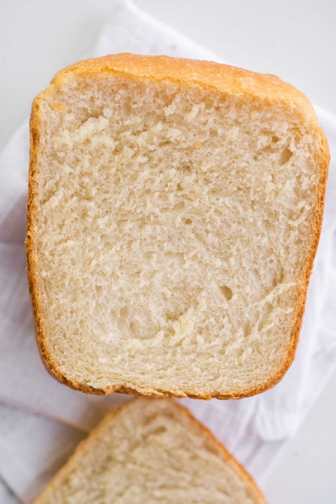 loaf of white bread cut open showing fluffy bread