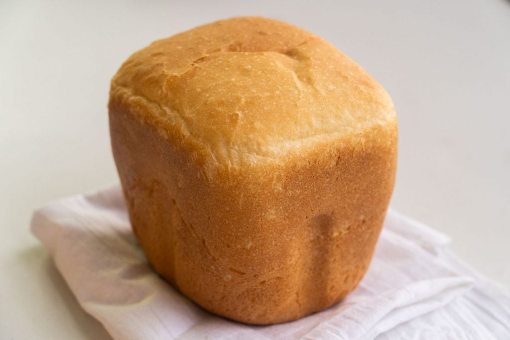 white bread loaf on flour towel