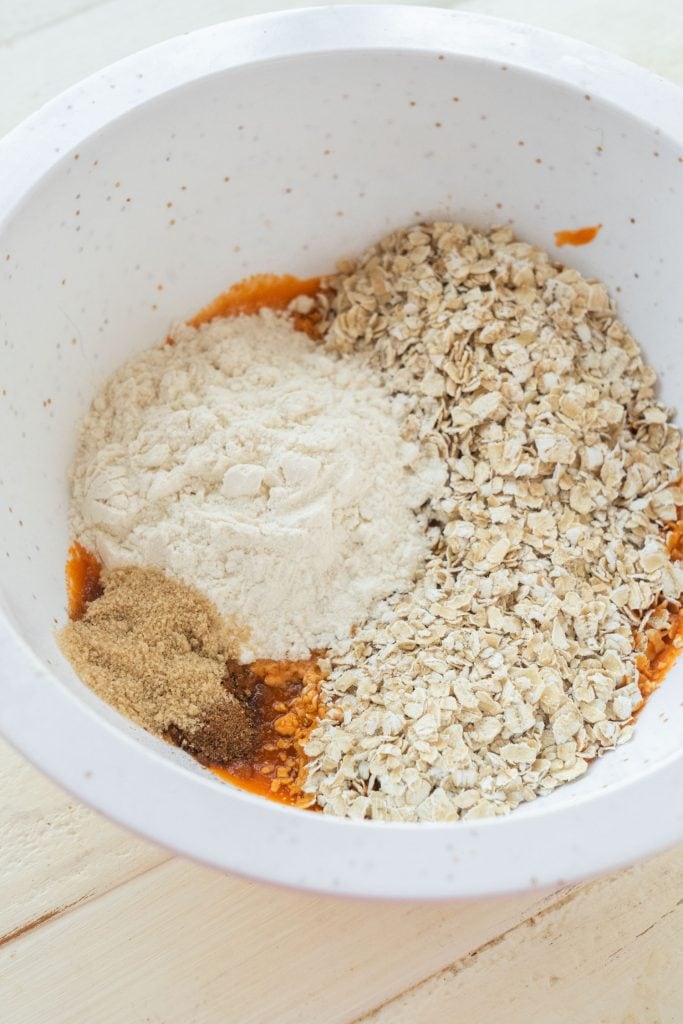 flour, oats, carrots, brown sugar and cinnamon in white bowl
