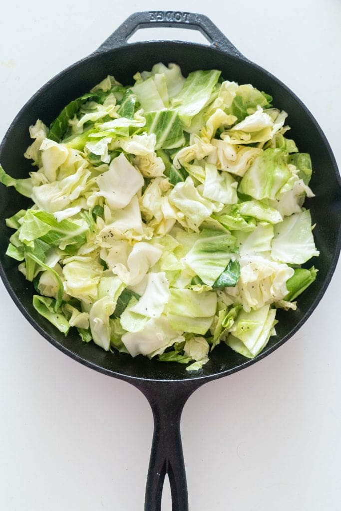 chopped up cabbage in cast iron skillet