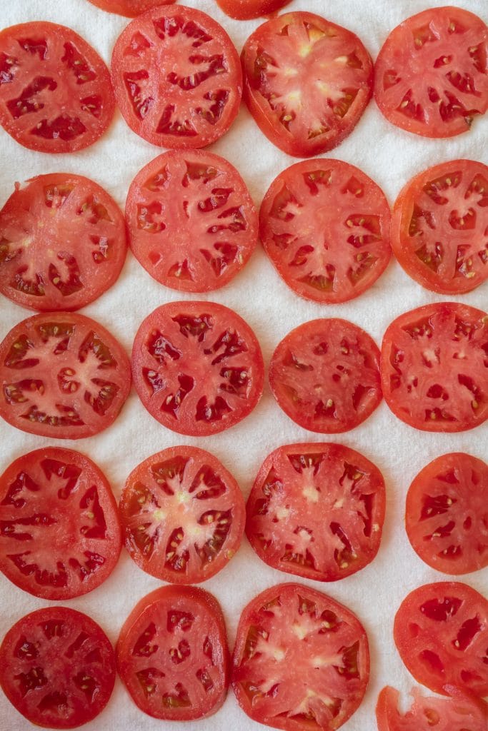 slices of tomatoes on white paper towel