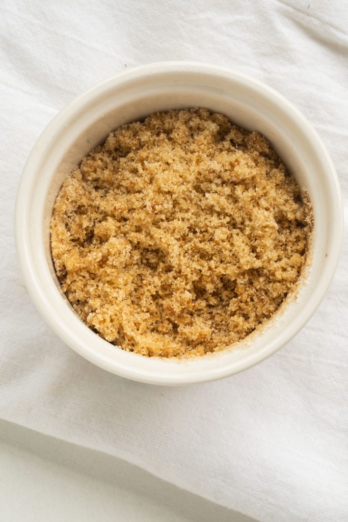 homemade fluffy brown sugar in white bowl on white towel