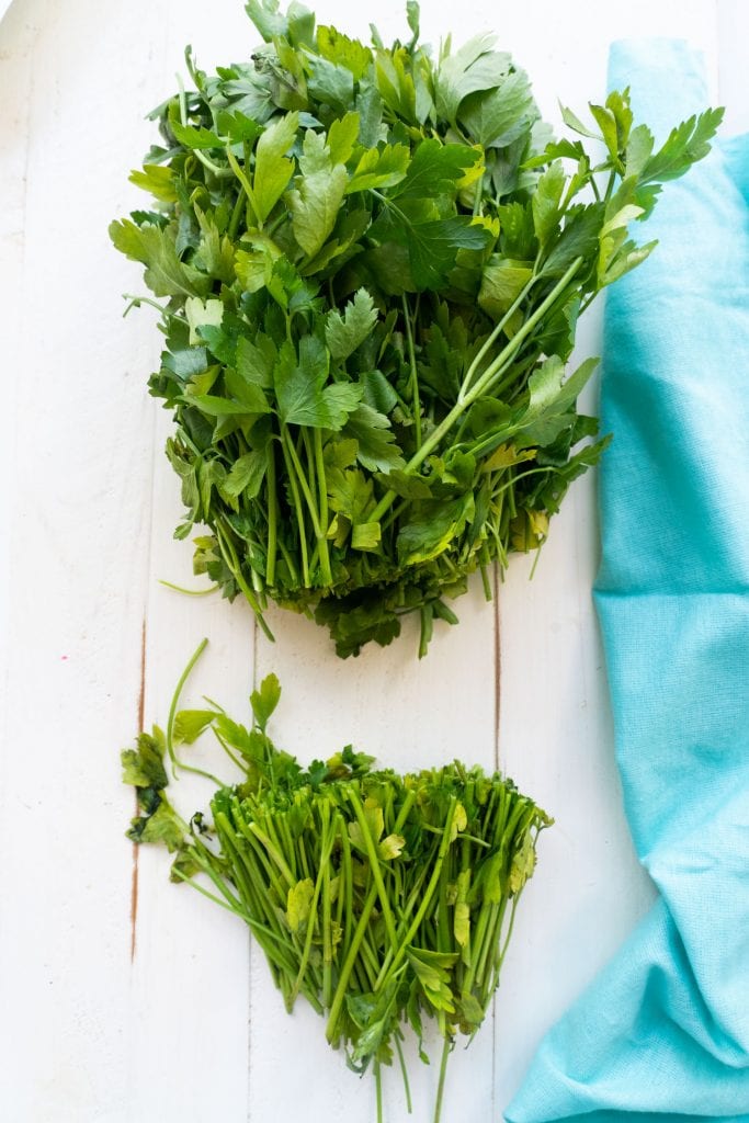 parsley stems chopped off on white table
