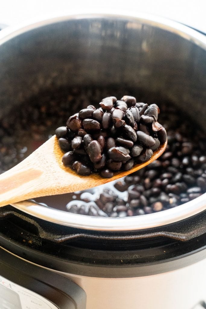 wooden spoon with black beans on it
