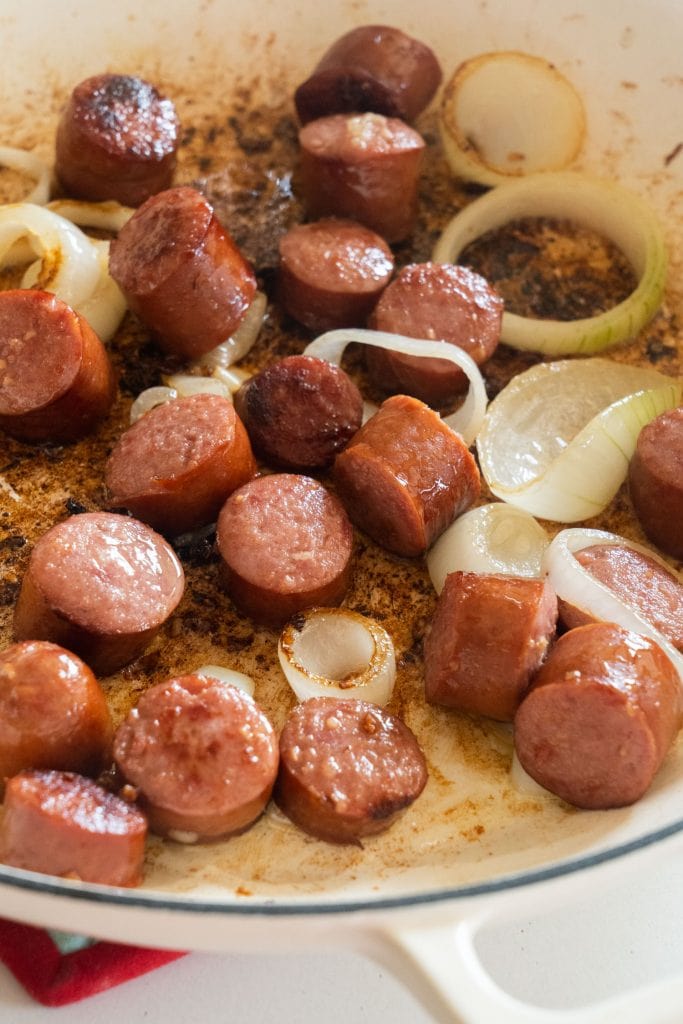 browned kielbasa sausage with onions in skillet