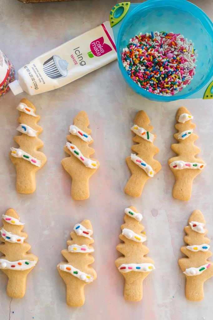decorating cookies with sprinkles and frosting.
