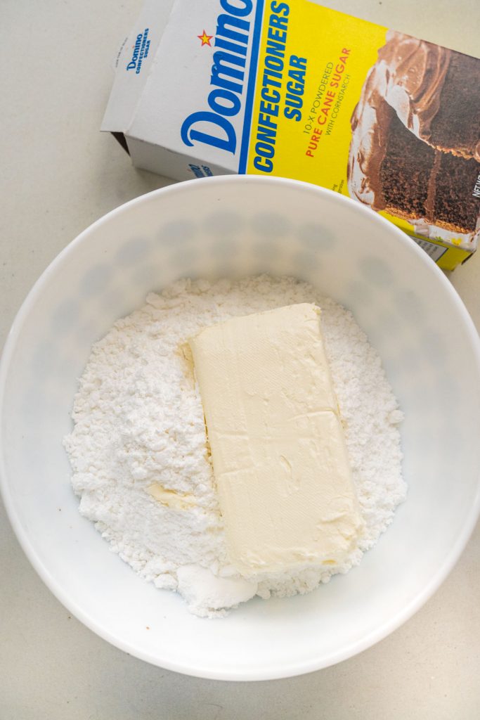 powdered sugar and cream cheese in white bowl