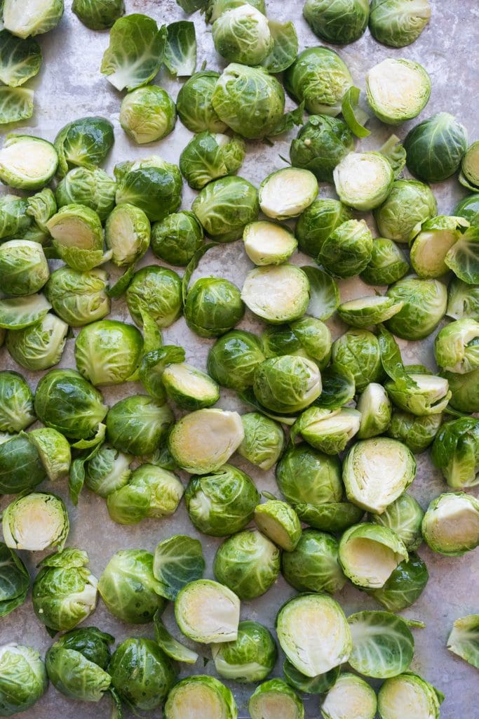 brussels sprouts cut in half on baking sheet