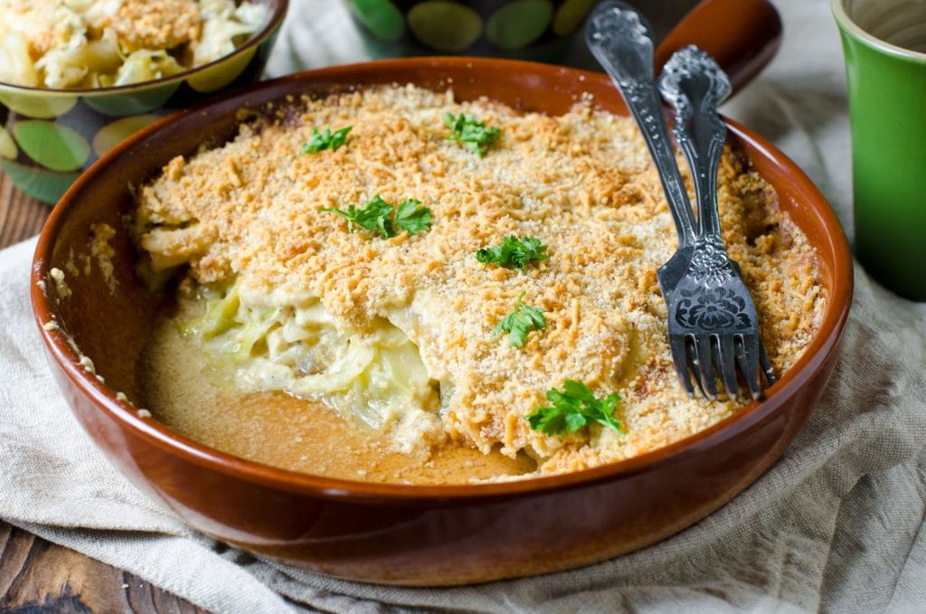 creamy cabbage casserole on white towel on table