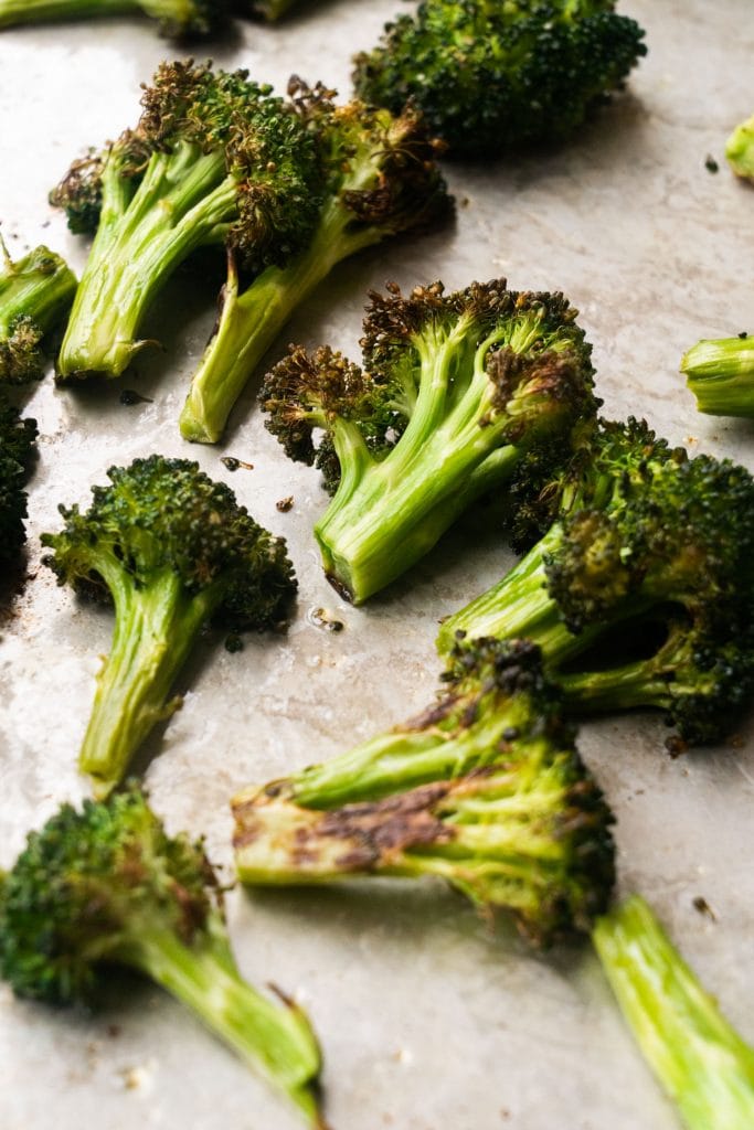 crispy broccoli with brown edges on baking sheet
